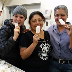 three cooperative workers pose with popsicles