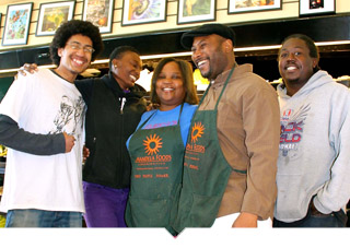 Group of worker owners stand together with aprons on