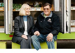 Married Couple and owners of mobile market seated in front of their truck