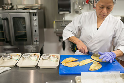 Preparing quesadillas for meal delivery