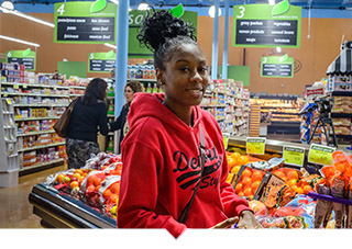 Young woman with Detroit sweatshirt shops at Grocery Store