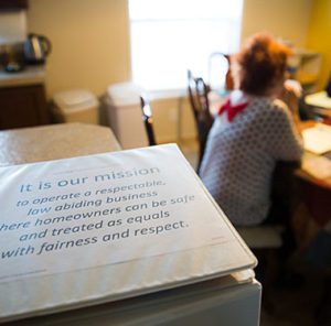 Cooperative Housing guidelines book with Mission Statement written on it.