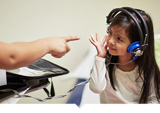 Little girl undergoes hearing test