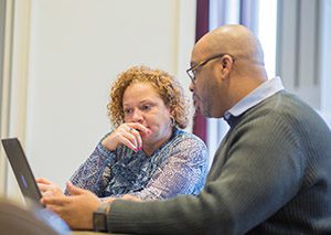 Melinda Clemons of Capital Impact works with a Detroit developer on plans for a building project.