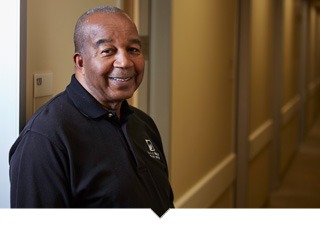 Charles Ranges stands in the hallway of his health center