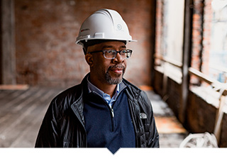 A minority developer at a Capital Impact financed projects looks at construction progress