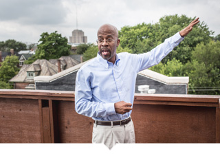 Richard Hosey stands on the rooftop of one of his Detroit projects.