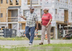 Detroit residents walk past renovated building in Detroit
