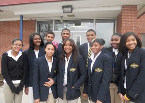 Students stand in front of their school.