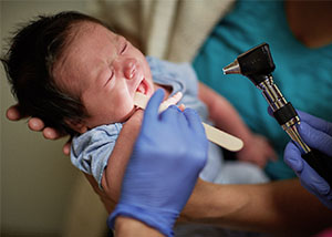 A baby receives a check-up at a community health center.