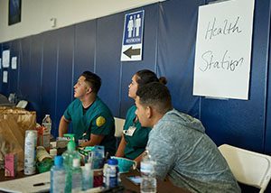 Medical staff wait to serve patients at an evacuation center.