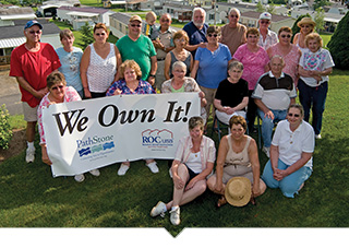 Members of a housing cooperative in front of their property.