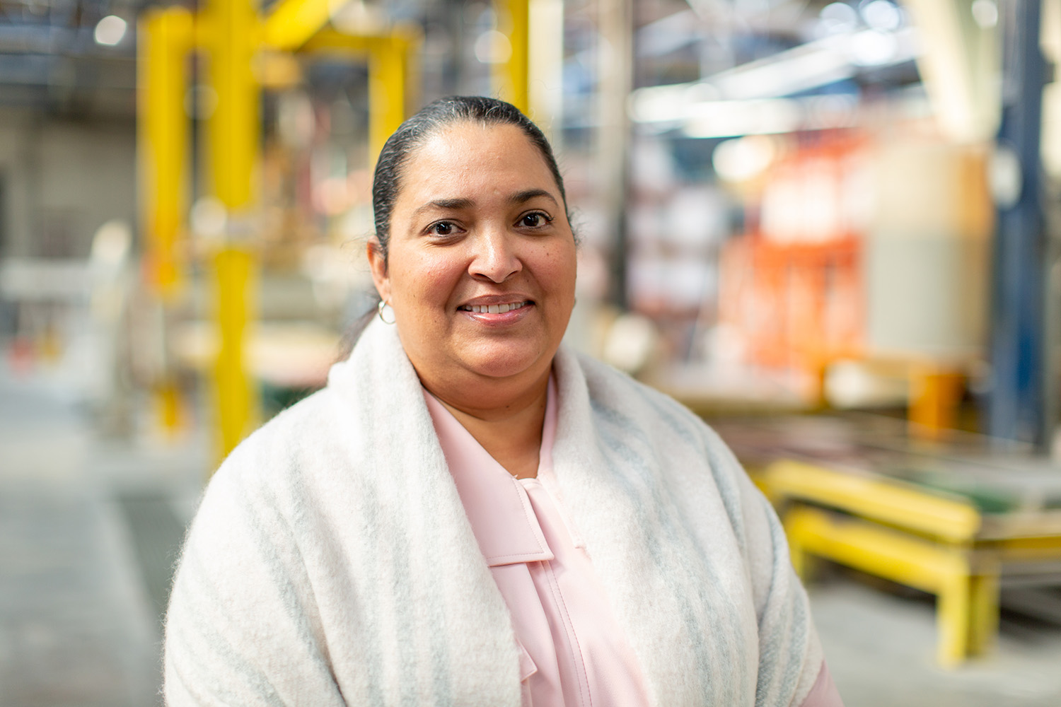 A worker-owner at a cooperative in New York stands in her warehouse.