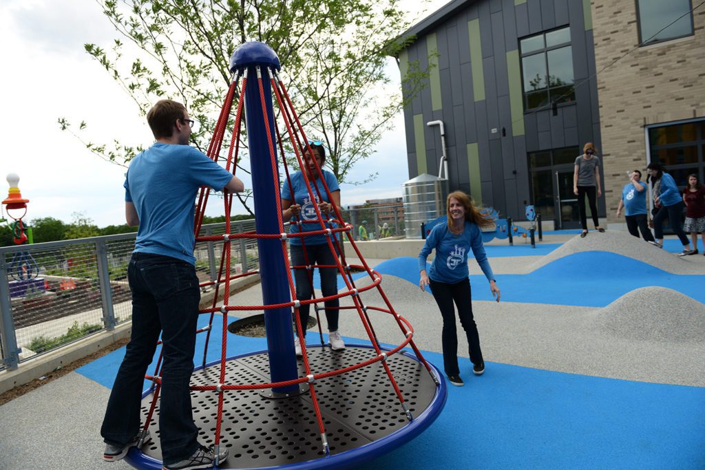 Capital Impact staff text out playground equipment at Martha's Table.