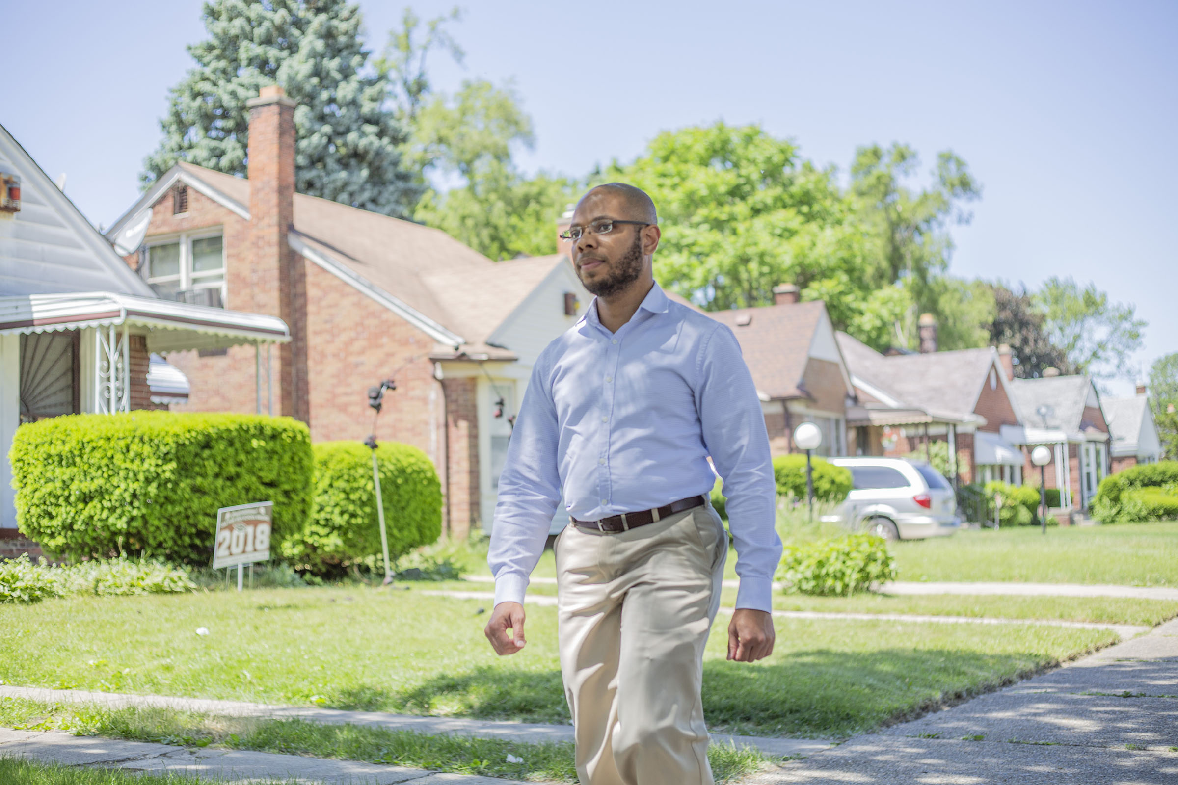 A man walks through a neighborhood