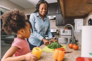 A woman and her daughter in their kitchen