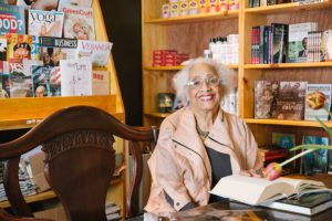 A woman sits in a bookshop