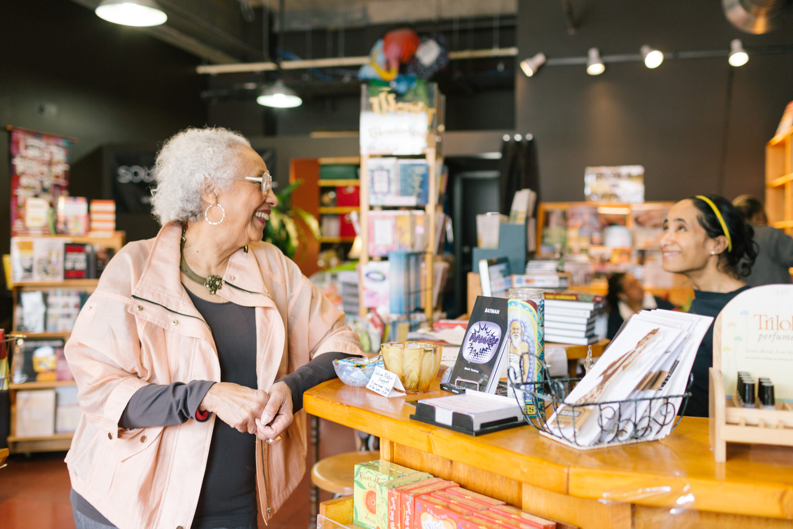 Janet Webster, owner of Source Booksellers, laughs with a girl