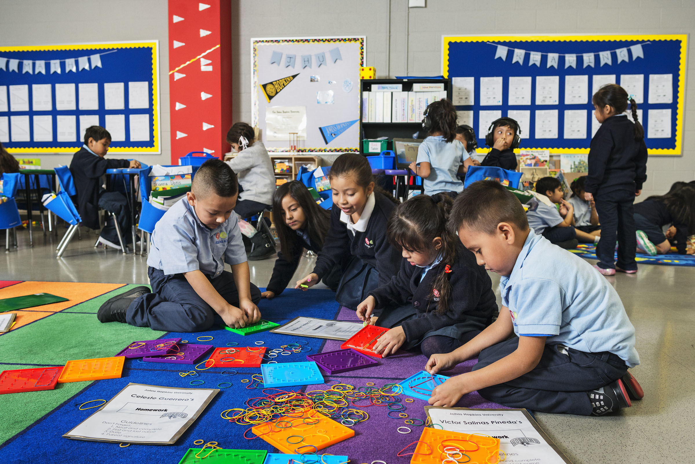 Students play on the floor in their classroom