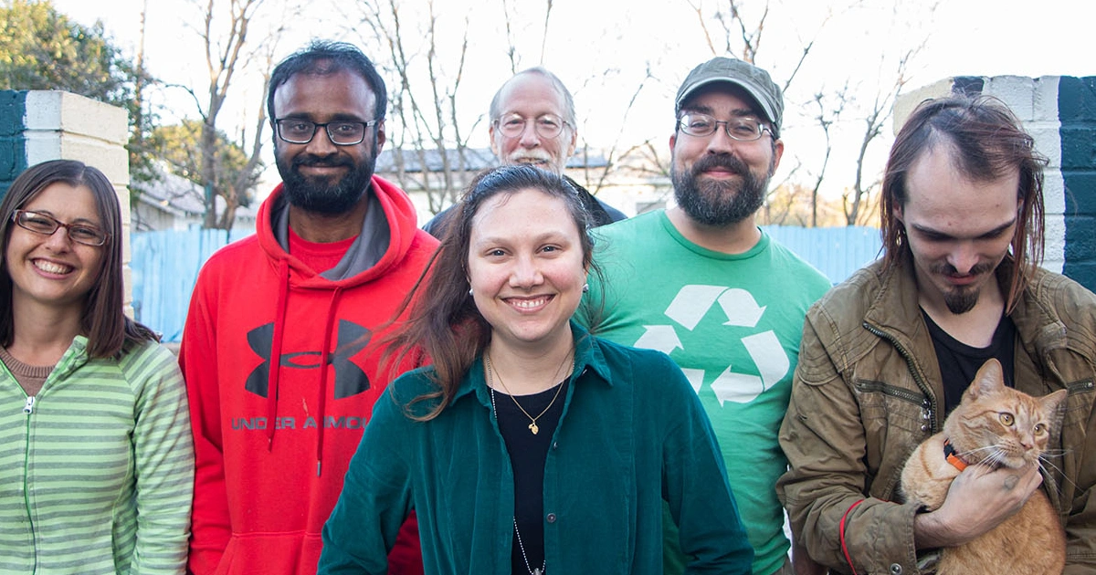 A group of La Reunion Housing Co-op residents pose for the camera.