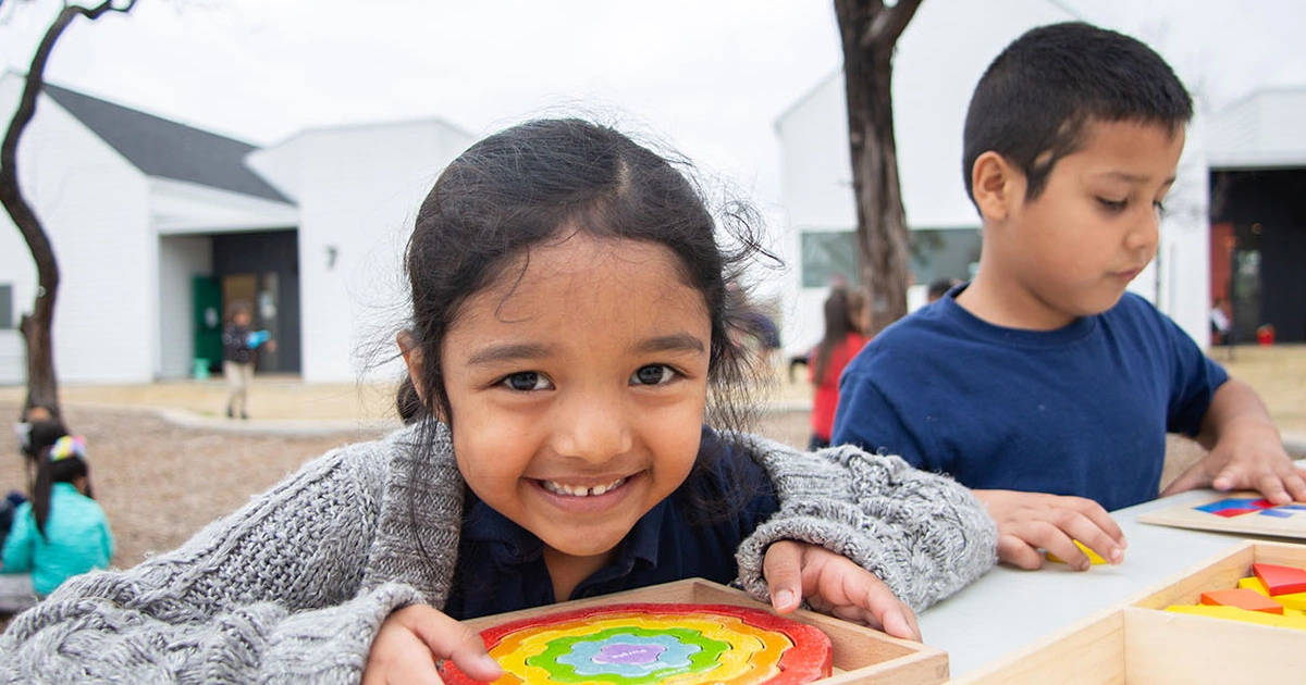 Montessori for All students works on art project outside.