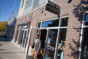 A man walking out of Source Booksellers