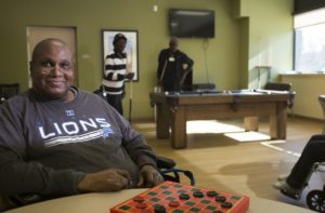 A man spends time with others in a senior assisted living facility