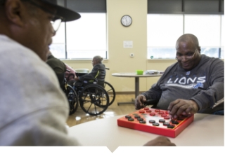 Older adult man plays checkers