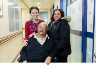 Older Adult woman poses with daughter and doctor