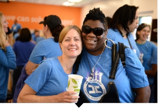 Two female Capital Impact employees pose for photo