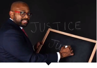 Capital Impact CEO Ellis Carr poses in front of the word Justice.