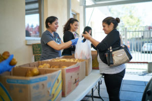 Workers selling produce at local California Farmers Market