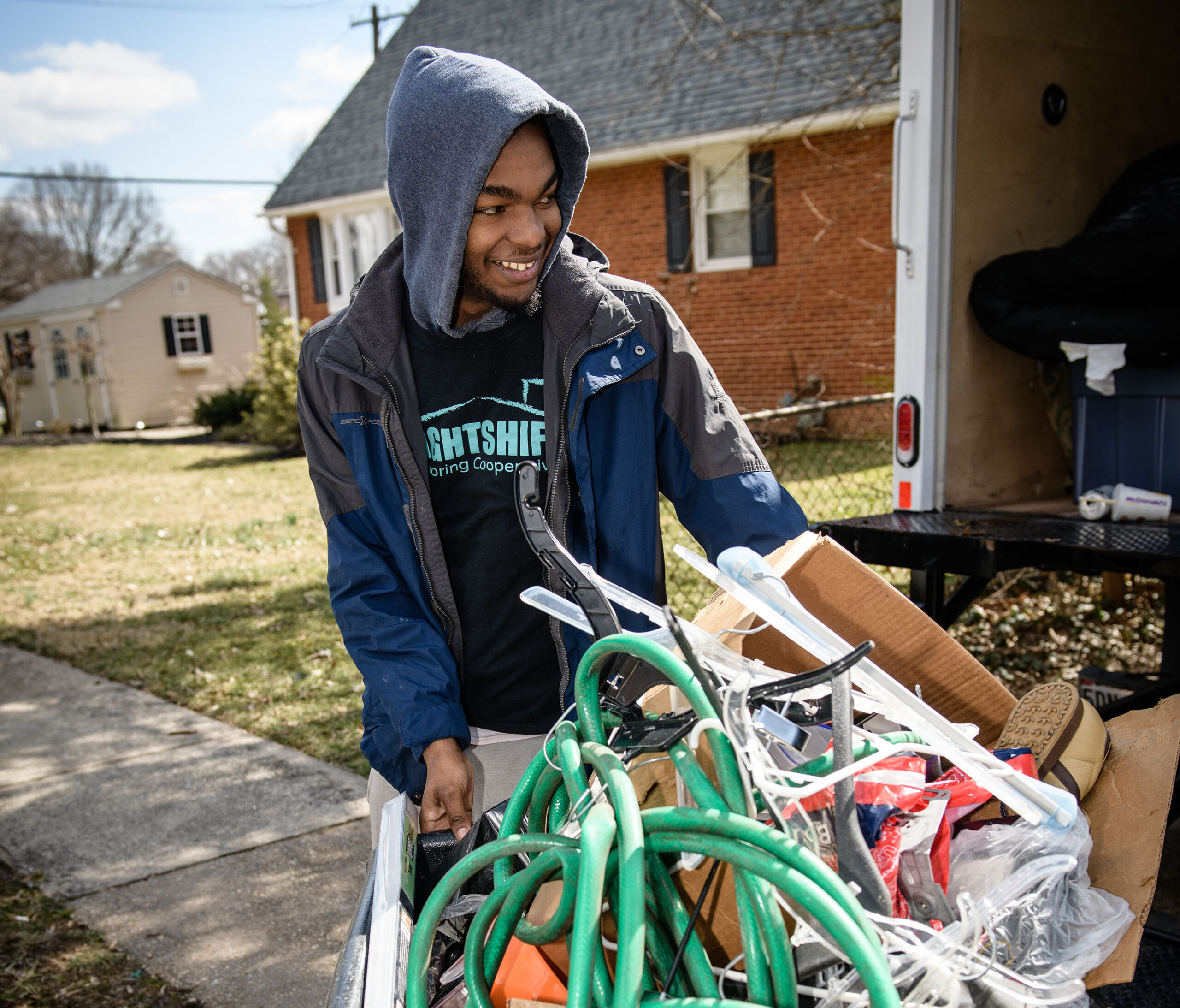 Man moves a garbage bin.