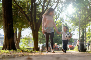 A mother and son walk together