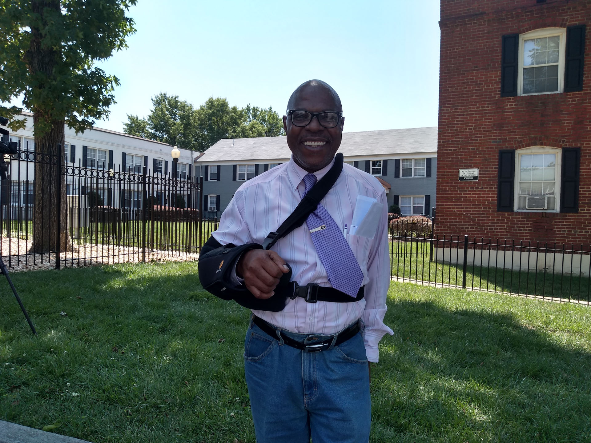 Man stands in front of his home