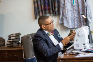 Black male business owner at sewing machine