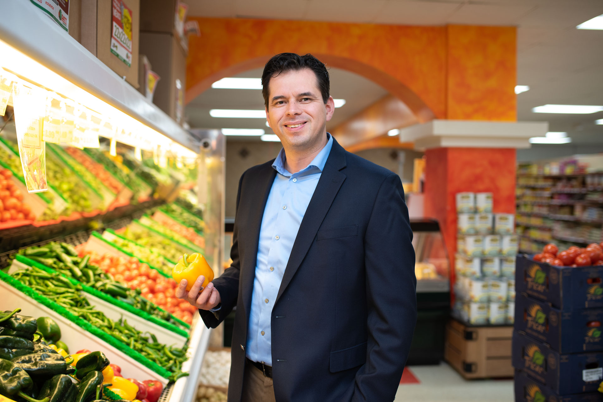 Man in a grocery store produce aisle