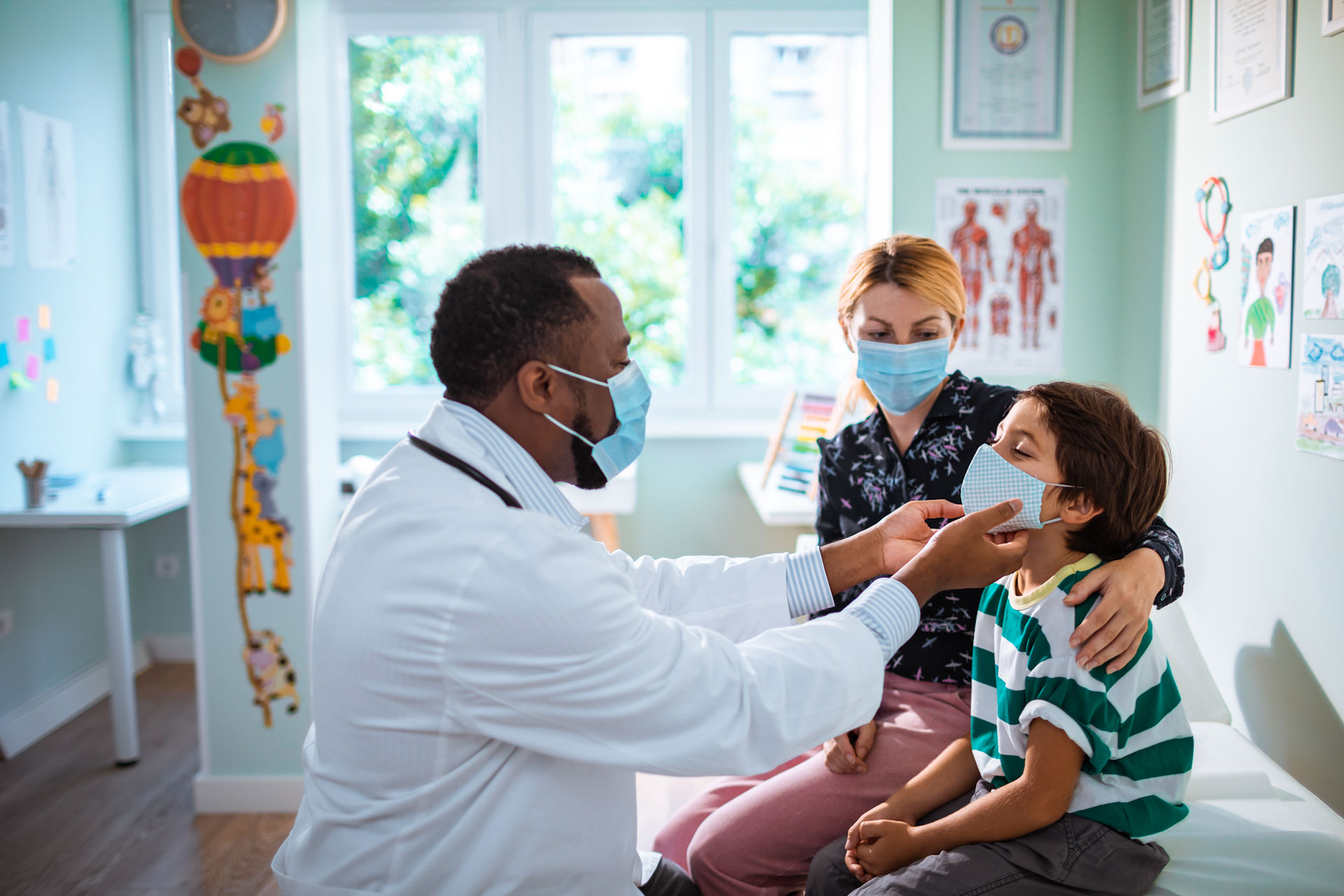 Mother and child with doctor for medical examination