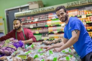 Staff stack food at Imperial Fresh Market