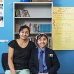 A child and an adult in a classroom. Funding from Capital Impact Investment Notes helps expand Capital Impact Partners' national footprint through organizations that provide access to critical social services, including health care, education, healthy foods, affordable housing, cooperatives, and dignified aging facilities.