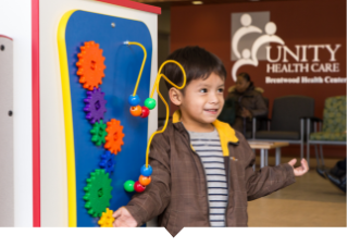 Young boy plays in lobby at Unity Health Care