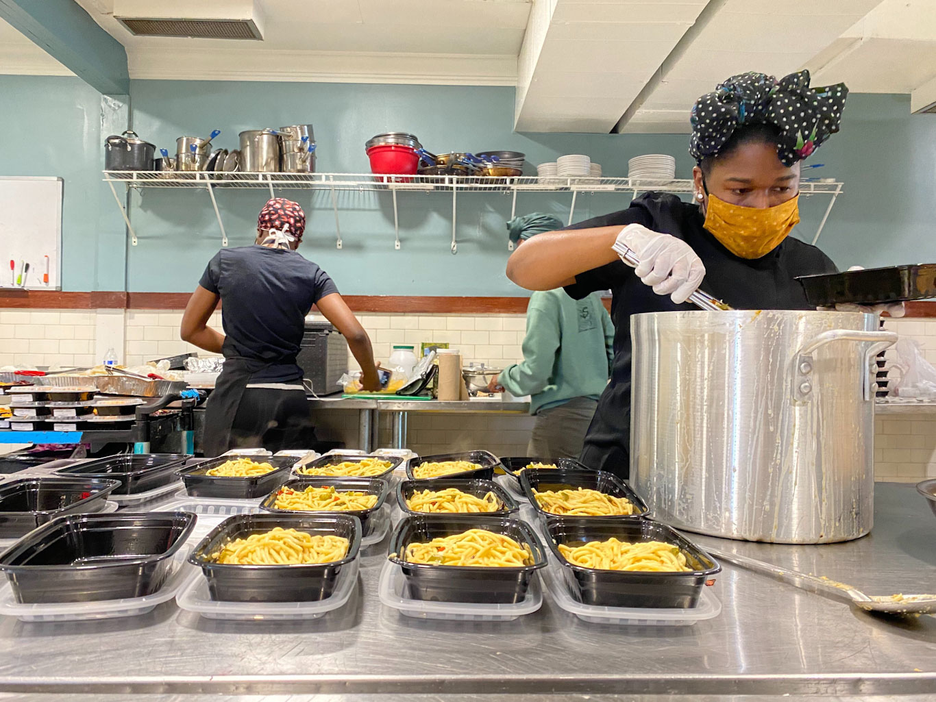 Women cook meals in a kitchen