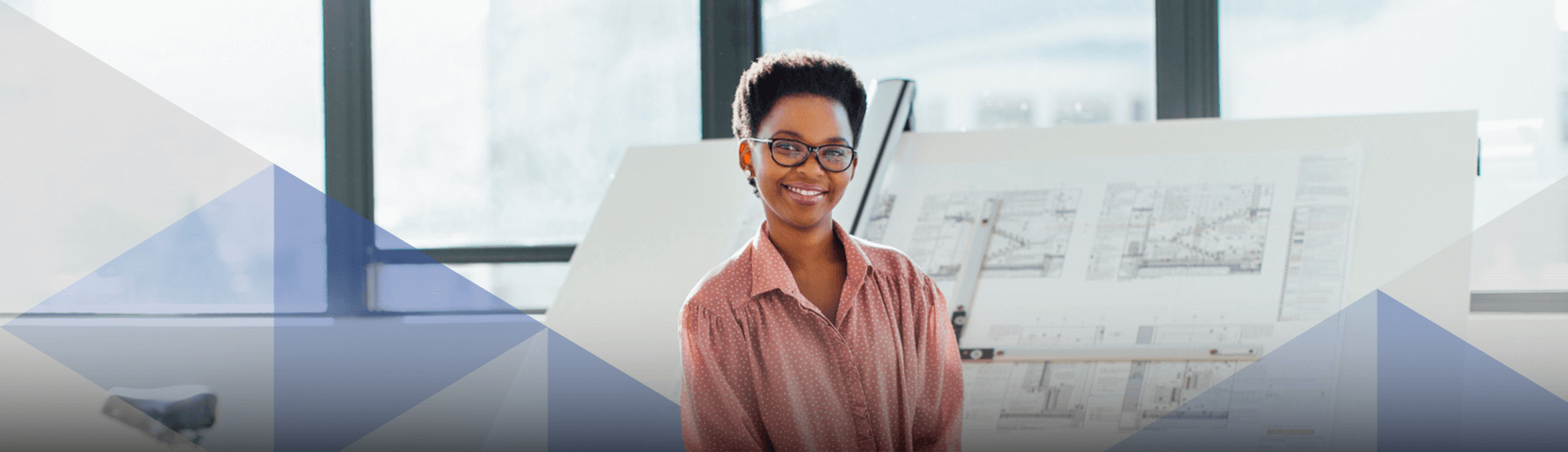 Black, female real estate developer poses in front of architectural drawing