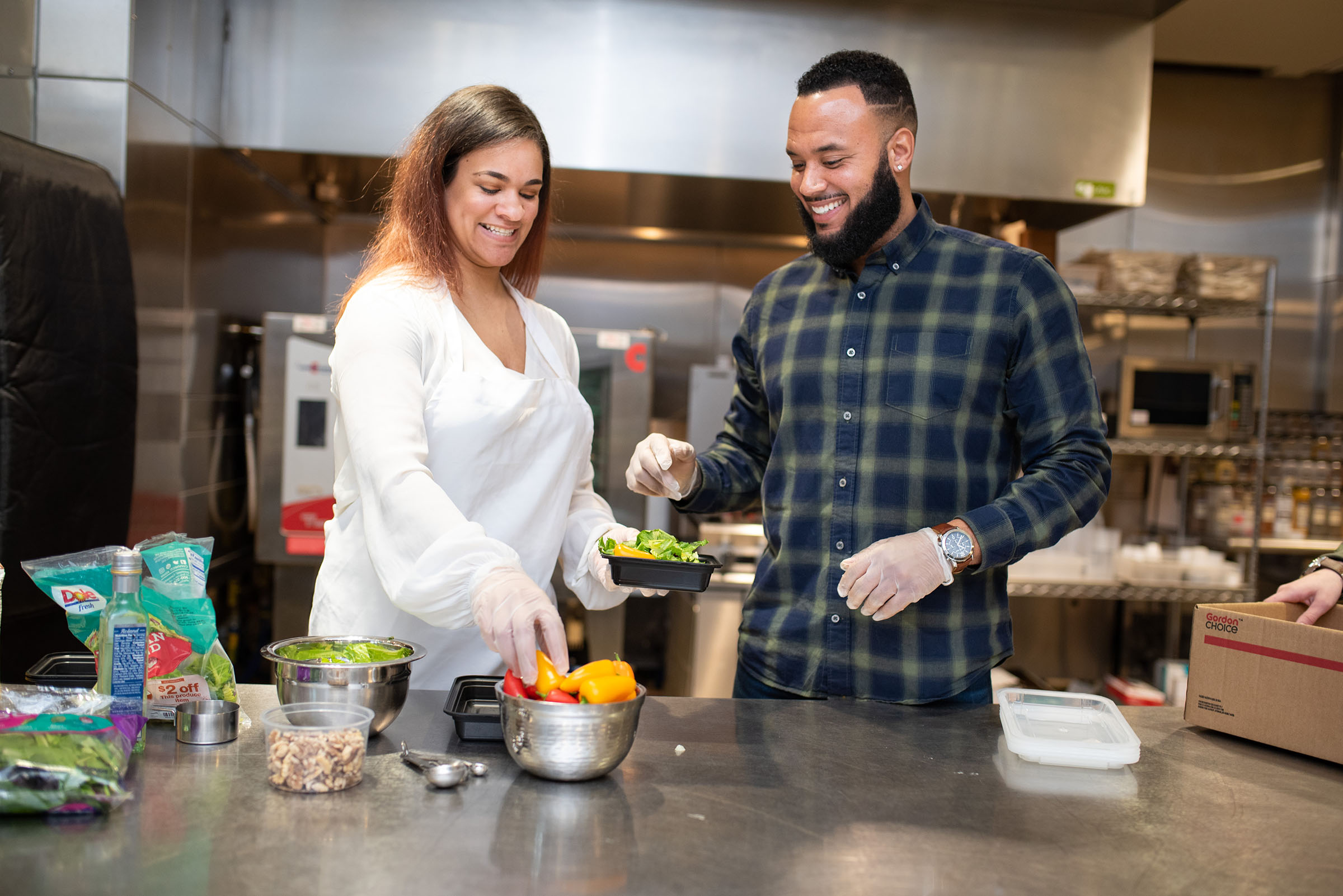 Business owners prepare food in the kitchen