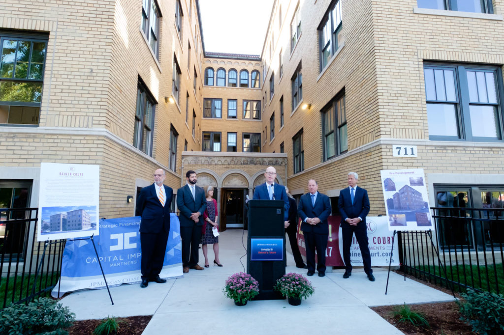 Former Capital Impact CEO Terry Simonette, Detroit Mayor Mike Duggan, and JPMorgan Chase CEO Jamie Dimon celebrate opening of Ranier Court