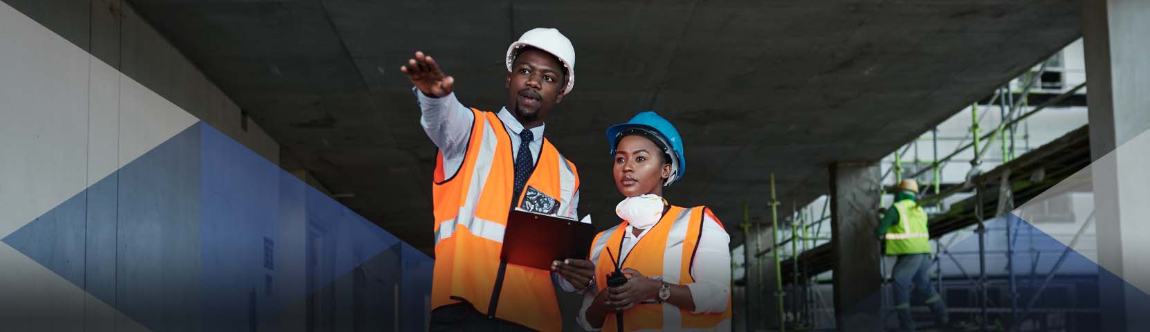 Man holds blueprint at a construction site.