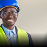 Man wears hard hat at a construction site.