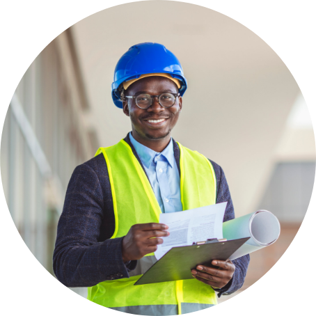 GDHD graduate wears hard hat at a construction site.