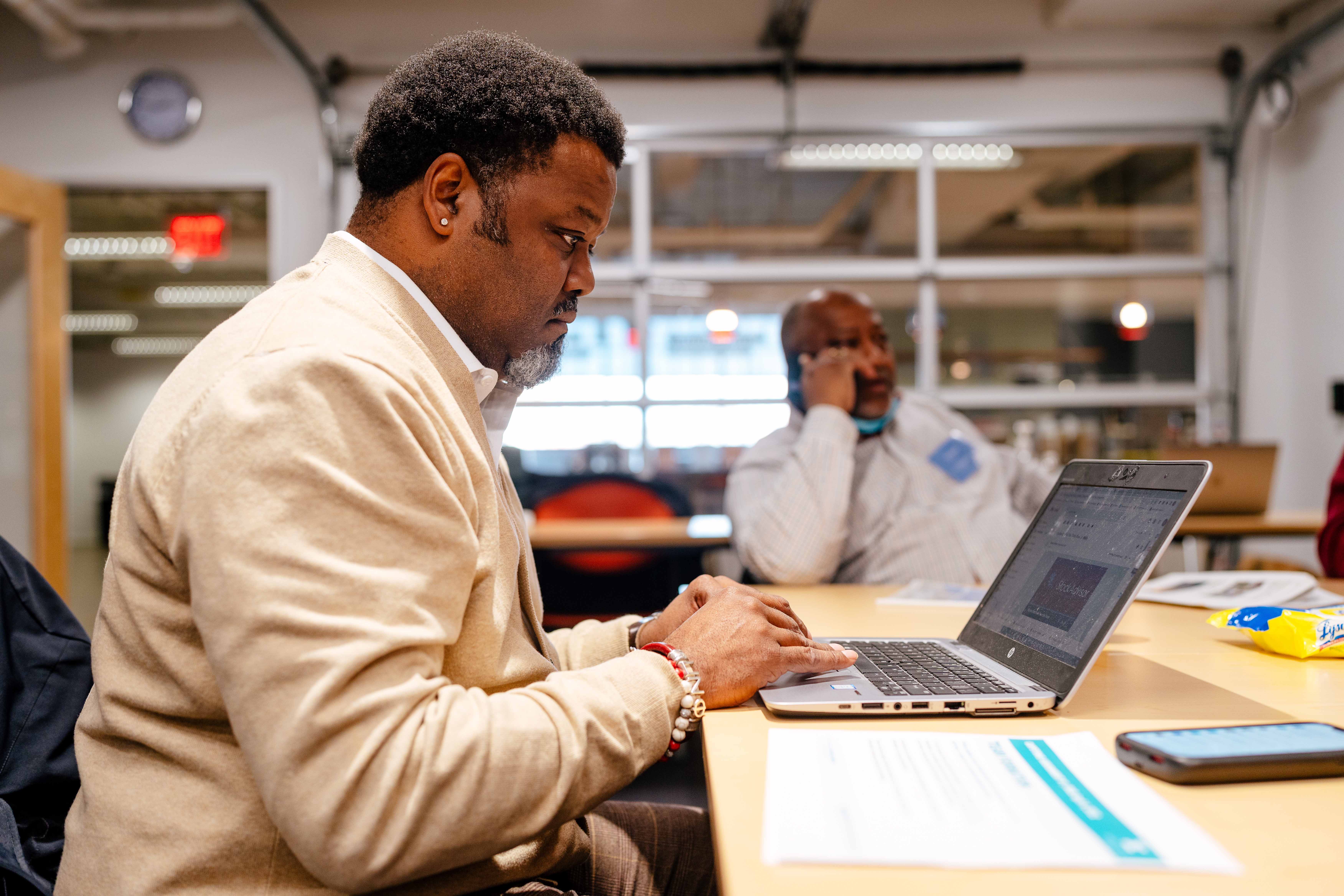 A real estate developer works on his laptop during a session of Detroit's Equitable Development Initiative, which seeks to break down racial barriers for real estate developers of color.