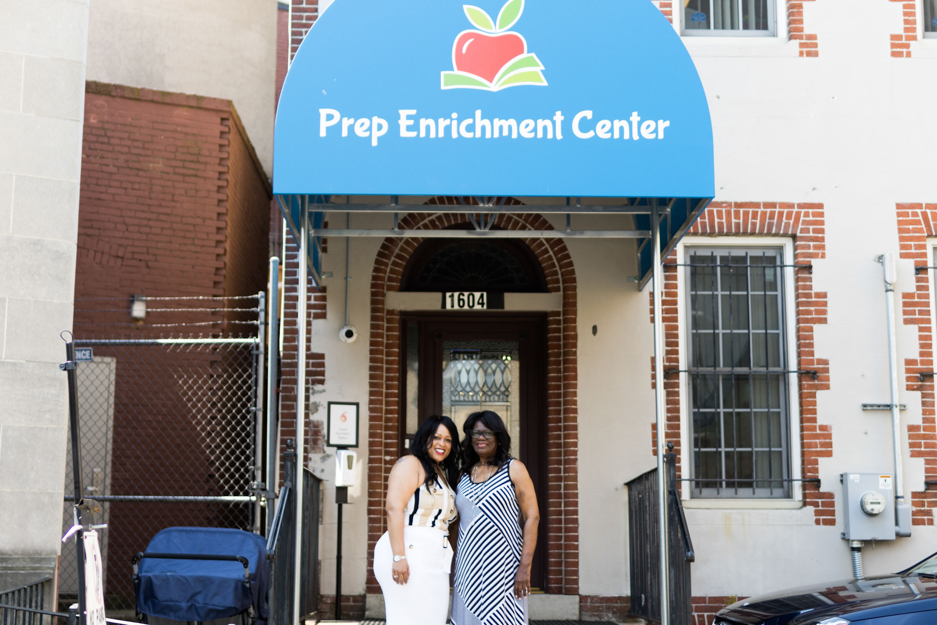 Naimah Simkins, standing in front of Prep Enrichment Center with her mother